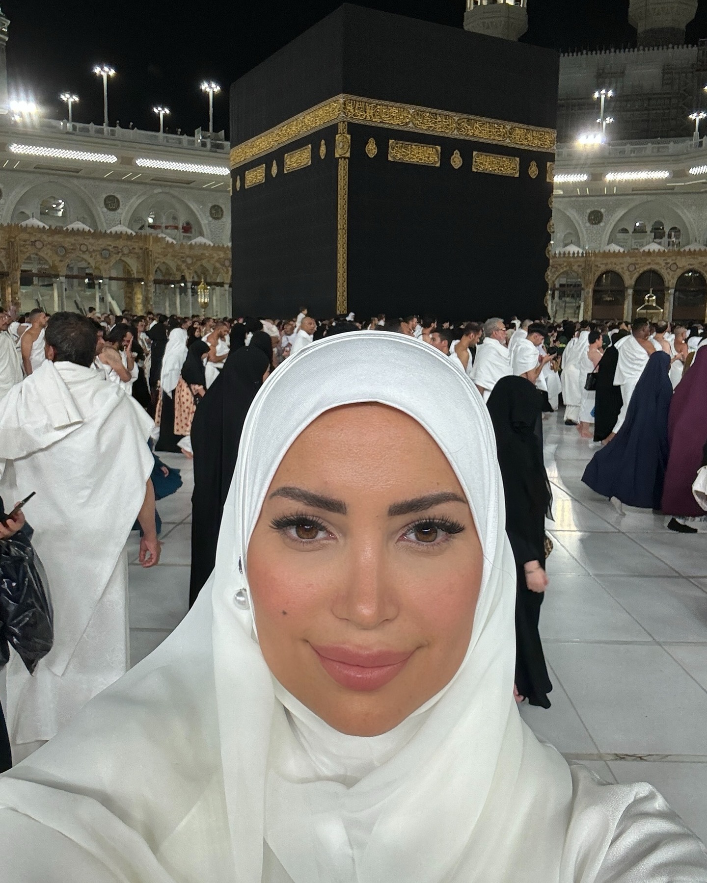 May be an image of 2 people, headscarf and text